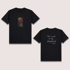 Basic T-Shirt Premium 100% COTTON 200 GSM 
Front and back view of a black streetwear tee. Front: 5x8 RGBY line art of praying hands with a cross, sun, and water elements in vibrant Red, Green, Blue, and Yellow. Back: 8x8 white text reading "The Lord Is my Shepherd" with "Psalm 23:1" below it. Only @ Tintahan-on-Thread
